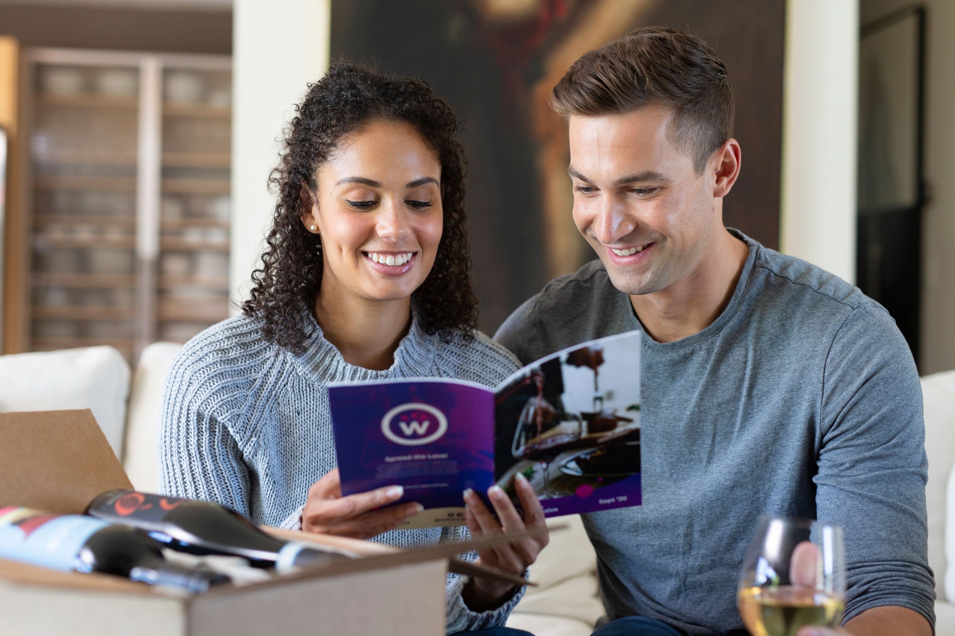 couple looking at wine subscription box